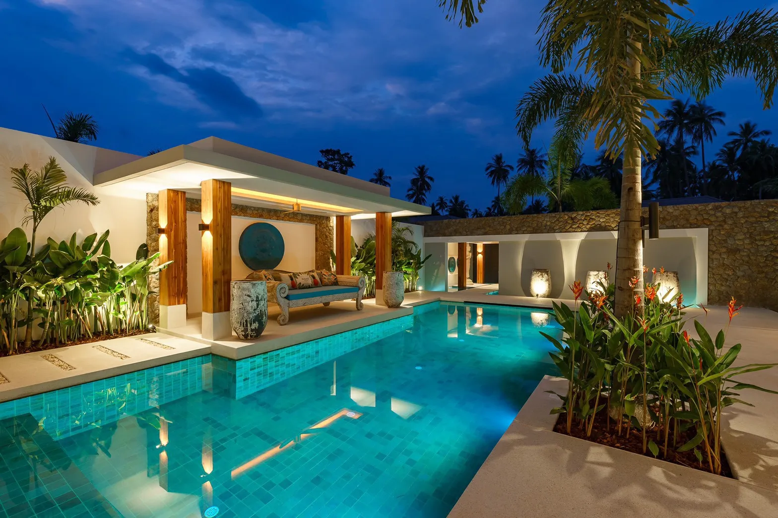 Illuminated walkway and water features at night, Koh Samui