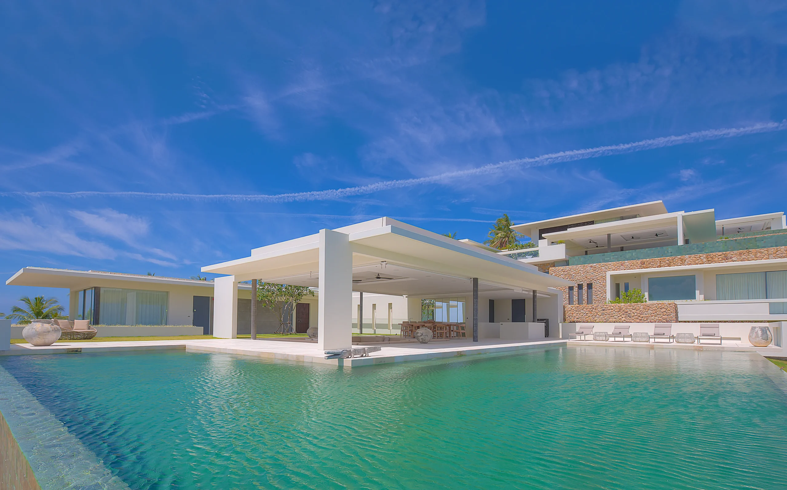 Pool view toward villa facade and covered lounge, Koh Samui