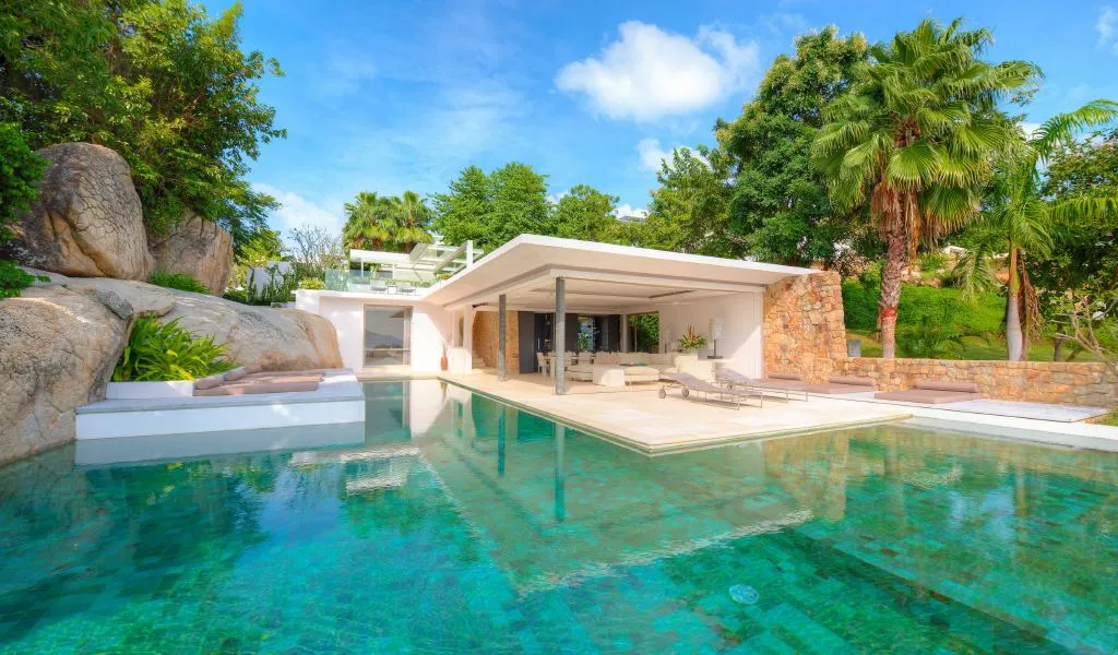 Tropical pool deck with palm landscaping and stone features, Choeng Mon, Koh Samui